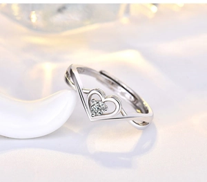 Macro view of silver V-shaped band setting with heart-cut diamond and adjustable ring