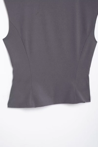 Detail view of the slim-fit waist and tailored back of the grey sleeveless commuter vest