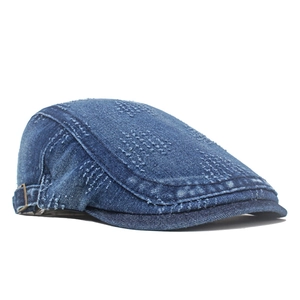 Washed denim newsboy cap with vintage distressed texture and side metal buckle detail