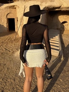 Sexy black long sleeve crop top with mesh sleeves and white textured mini skirt