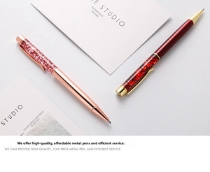 Detailed shot of rose gold and red metal pens with sparkling glitter and crystal filling