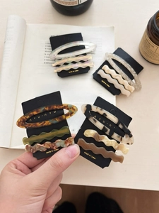 Detail view of acetate hair clip set in tortoise shell and marble textures on display card