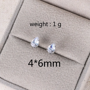 Detailed view of silver pear-cut zircon stud earrings in a box with 1g weight and 4x6mm size