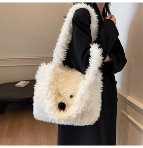 Detail of soft white plush shoulder bag featuring a cute minimalist polar bear face design