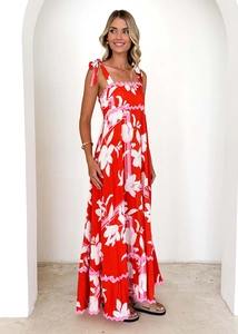 Detail of red floral maxi dress with scalloped edges and shoulder ties on model