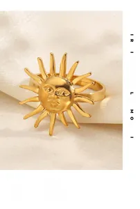 Detailed view of 18K gold plated stainless steel sun face ring on white silk fabric