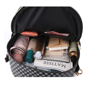 Internal capacity of black geometric travel bag showing space for books and umbrella