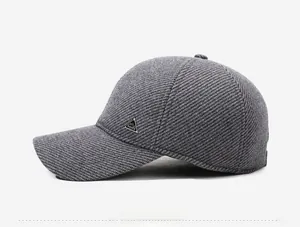 Close-up of the side profile showing thick gray twill texture and metal detail on men's winter cap