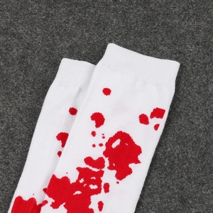Close-up of white Halloween socks with realistic red blood splatter print texture.