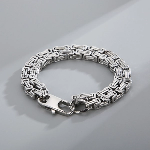 Close-up of polished silver stainless steel Byzantine chain bracelet with square links