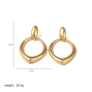 Detailed view of large gold-tone irregular geometric earrings with size and weight info