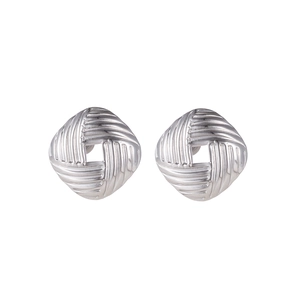 Detail of silver geometric earrings with woven texture and central hollow square design