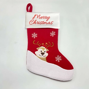 Detail of red Christmas stocking with embroidered reindeer and Merry Christmas text