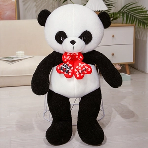 Detail of soft black and white plush panda toy featuring a red Love heart bow accessory