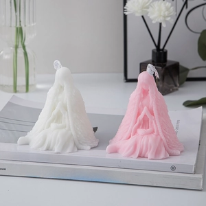 Elegant praying girl art candles in white and pink displayed on minimalist art books