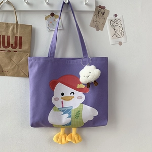 Detail of purple canvas tote bag with 3D yellow duck feet and cartoon print