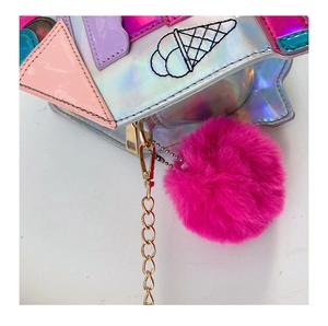 Detail of laser holographic ice cream crossbody bag with embroidery and pink pompom
