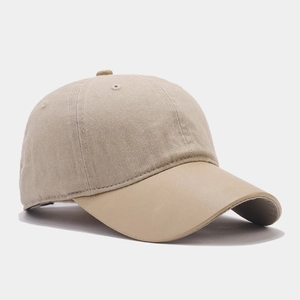 Close-up of contrast beige twill baseball cap with faux leather brim and stitched eyelets