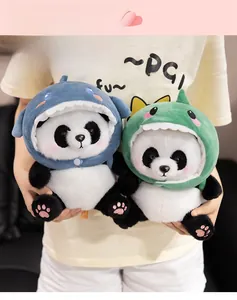 Soft panda plush toys wearing cute shark and dinosaur hoodies shown in hand detail