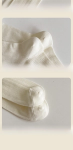 Detail of cream white ribbed knit socks showing elastic cuffs and reinforced heel texture