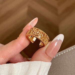 Detailed view of an 18K gold plated ring featuring a rose motif and zircon crystals