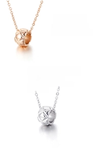 Detail of rose gold and silver hollow ring pendants with geometric rhombus engraving