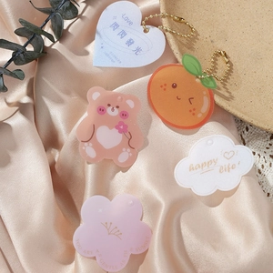 Cute acrylic charms set with pink bear and flower designs on elegant satin background