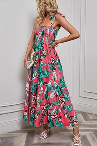 Detail of red floral tiered maxi dress with tie straps and smocked bodice detail