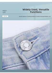 Macro shot of silver magnetic metal buttons installed on light blue denim jeans fabric