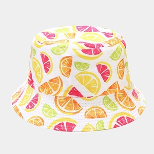 Detail of white cotton sun hat featuring vibrant citrus fruit slices and neat stitching