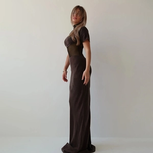 Deep brown short sleeve maxi dress with sheer mesh side patchwork in a studio setting