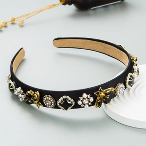 Elegant headband with golden bees, rhinestones, and pearls on black satin fabric wrap