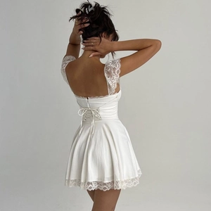 White backless mini dress with lace trim and corset style tie-back satin finish
