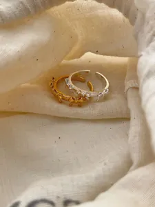 Detailed macro view of S925 sterling silver bow rings in gold and silver colors
