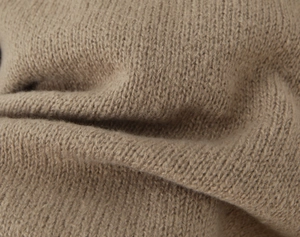 Macro shot of high-quality khaki knit cardigan fabric with soft premium texture