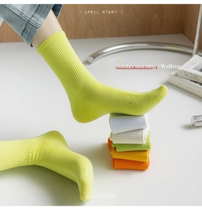 Detailed knit texture of vibrant fluorescent yellow ribbed cotton crew socks for women