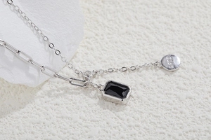Detailed macro view of S925 silver necklace with black rectangle gemstone pendant