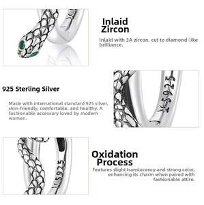 Macro detail of S925 sterling silver snake earrings with 3A green zircon stone inlay