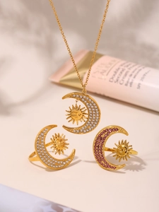 Detail view of 18K gold sun and crescent moon jewelry set with sparkling zircon stones