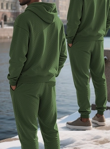 Detail view of olive green men hoodie and jogger set with premium jacquard texture