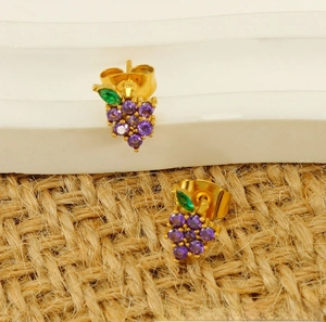 Detail of gold titanium steel grape studs featuring purple and green zircon crystals