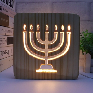 Detailed view of 3D wooden night light with glowing Menorah cutout and LED warm light