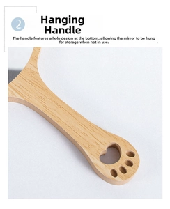 Detail of wooden hand mirror handle with a cute cat paw cutout for hanging storage