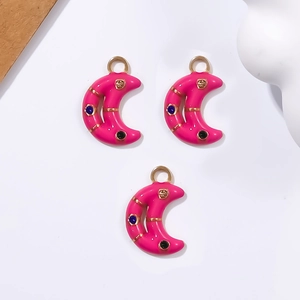 Pink enamel crescent moon pendants with gold trim and tiny gems for DIY jewelry making