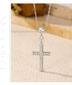 Macro detail of S925 sterling silver cross pendant with sparkling pave-set zircons