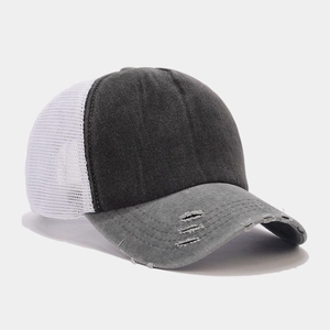 Close-up of distressed washed denim baseball cap with grey mesh and ripped brim details