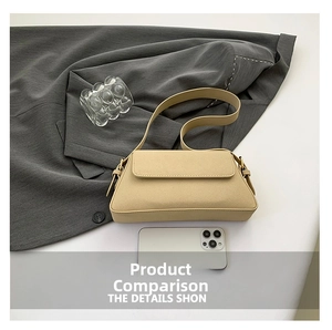 Detail view of a beige suede trapezoid baguette bag on a grey suit fabric background