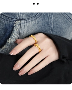 Close-up of gold hollow rings set with irregular textures and sparkling stones for women