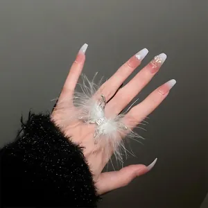 Elegant feather butterfly open ring with square rhinestone on a hand with luxury nail art