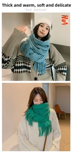 Detailed texture of thick soft winter scarf with fringe in hazy blue and emerald green